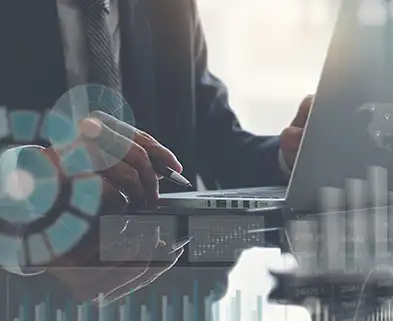 person sitting with laptop with many different data sources surrounding it - signifying classification